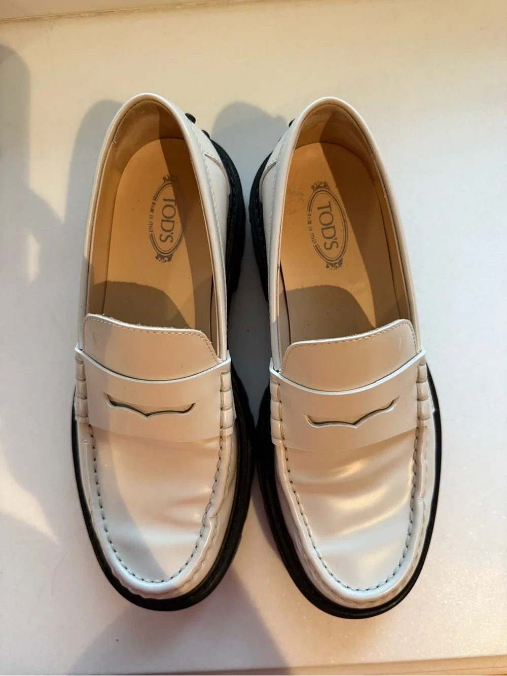 Tod’s Women’s White Leather Penny Loafers with Black Lug Sole - Picture 2 of 7